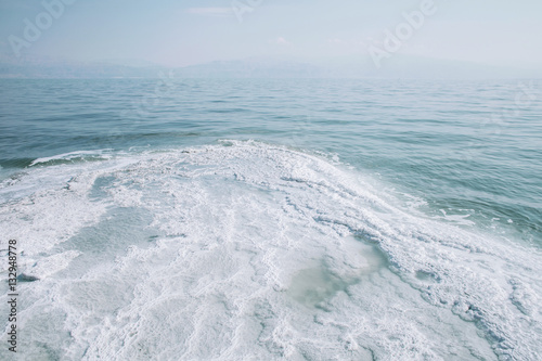 Scenery of Dead sea salty white shore and calm water