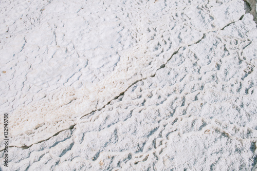 Cracks on dry white salty ground near Dead sea