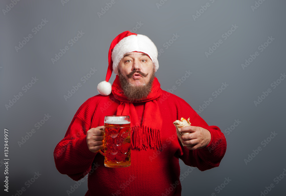 An elderly man with a beard in the cap of Santa Claus with a glass of beer and a hot dog An elderly man with a beard in the cap of Santa Claus with a glass of beer and a hot dog