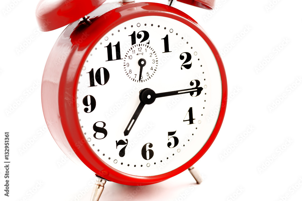 A quarter past seven on a round red alarm clock on white background -  isolated Stock Photo | Adobe Stock