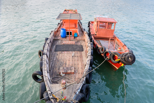 Two old fishing boats floating at jetty