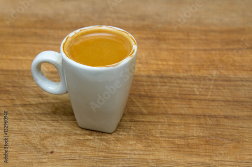 hot cup of espresso on a wooden background