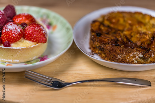 Two Dishes With Cakes and Fork On Wooden Table