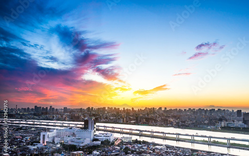 Business and culture concept - panoramic modern city skyline bird eye aerial view with Mountain Fuji under dramatic sunset glow and beautiful cloudy sky in Tokyo, Japan