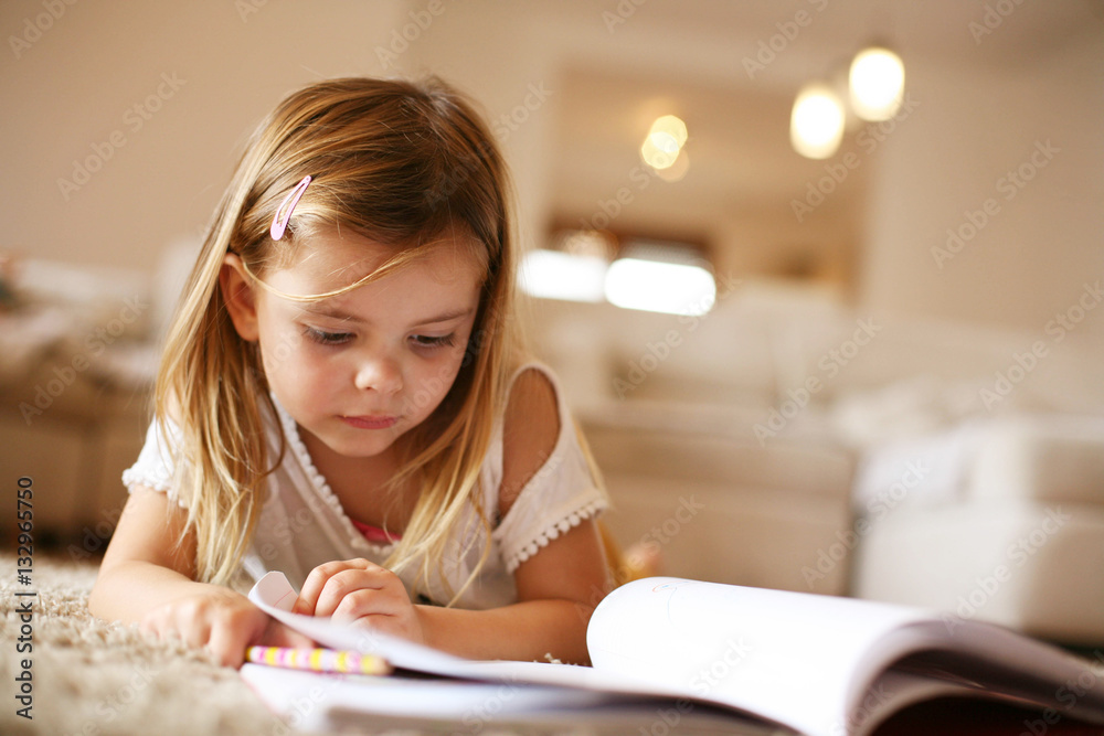 Little  girl reading  at home.