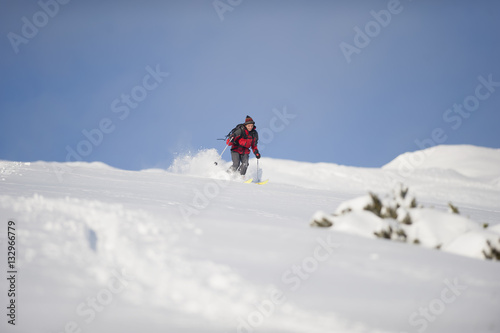 Skillful skier skiing downhill in nature on winter time.