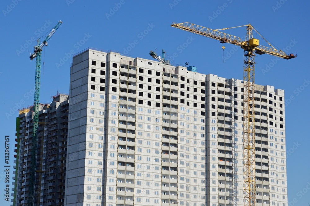 Construction of a skyscraper monolith and brick construction elements from a number of tower crane. Construction of a skyscraper monolith and brick construction elements from a number of tower crane.