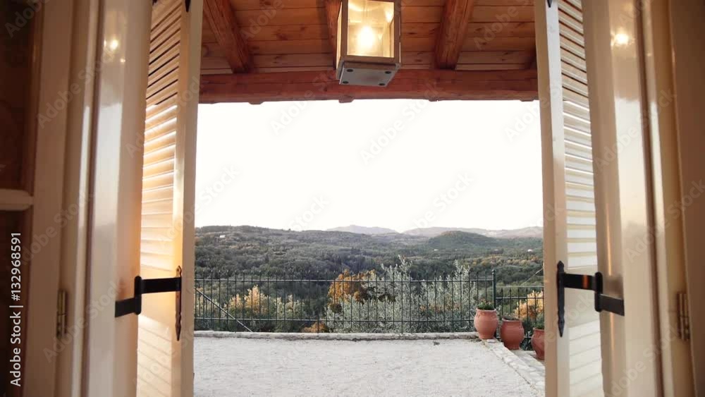 camera tracking through window of a villa revealing the view