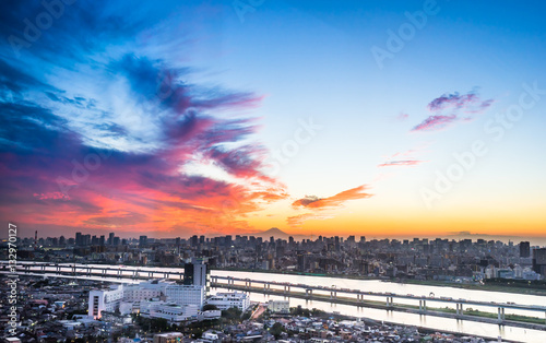 Business and culture concept - panoramic modern city skyline bird eye aerial view with Mountain Fuji under dramatic sunset glow and beautiful cloudy sky in Tokyo, Japan
