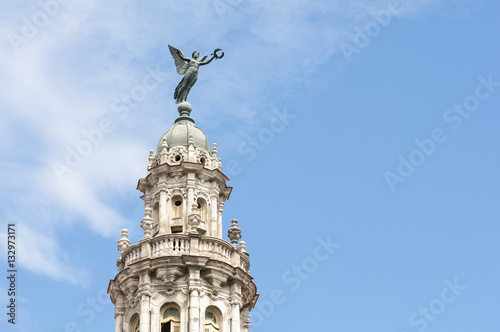 Close up of the top of the Grand Theater of Havana, Cuba against bright blue sky © lazyllama