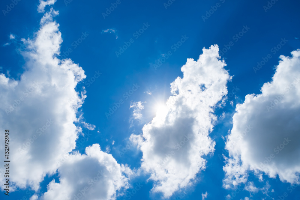 Looking up at sun behind cloud with nice blue sky Looking up at sun behind cloud with nice blue sky