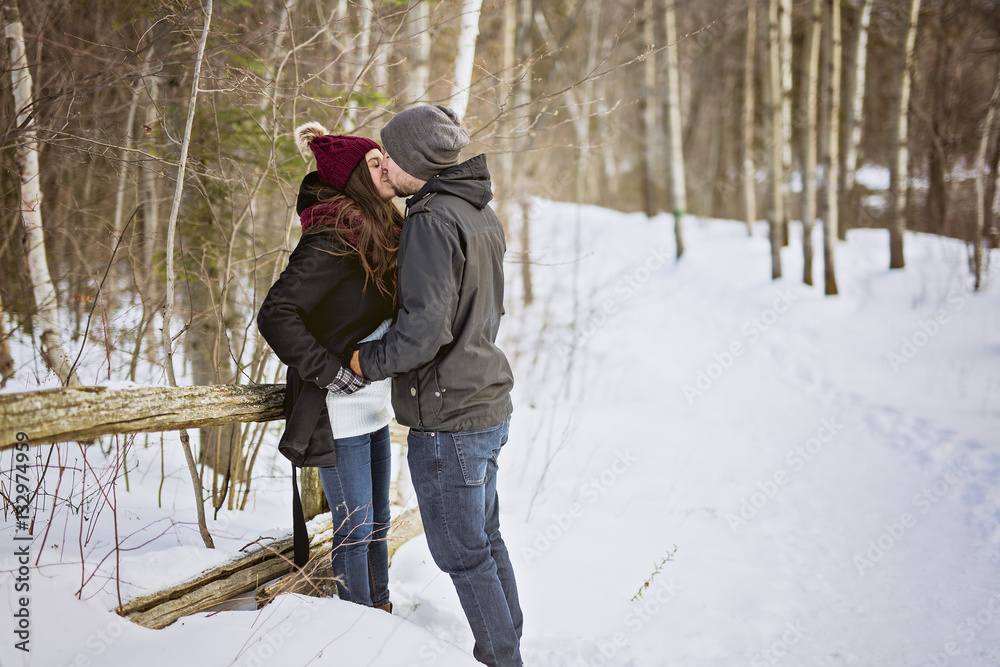 Pregnant couple have fun in winter nature