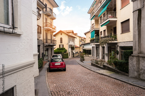 Road and town buildings. Cars parked in the street. Spend Summer in Italy. © DenisProduction.com