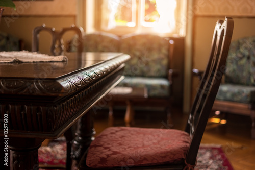 Antique table and chair. Classic room interior. Victorian furniture for sale.