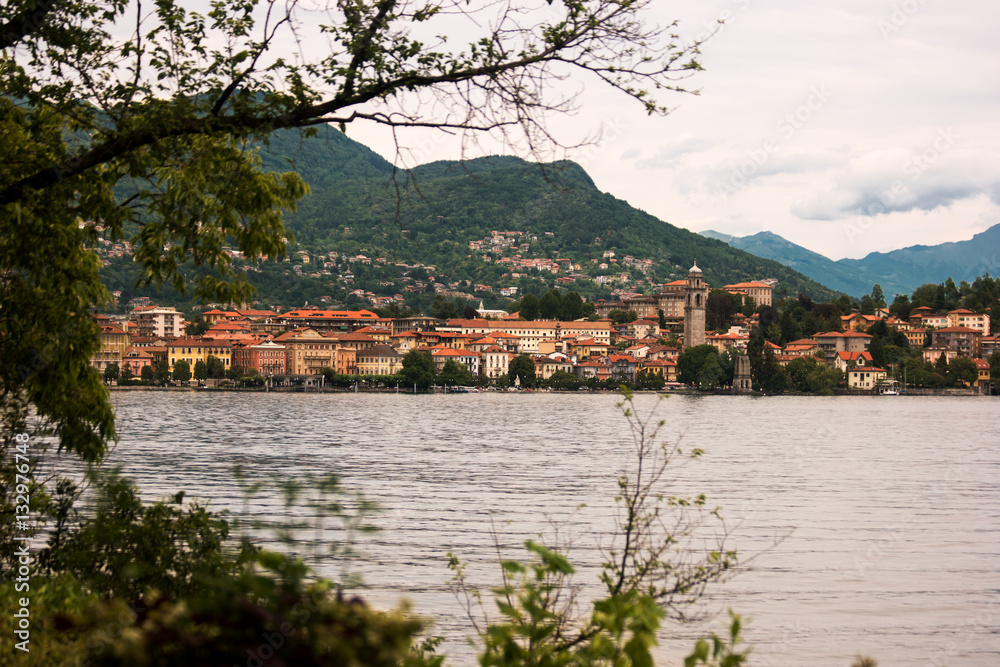 Water and town buildings. Sky and green mountains. Summer trip to Stresa.