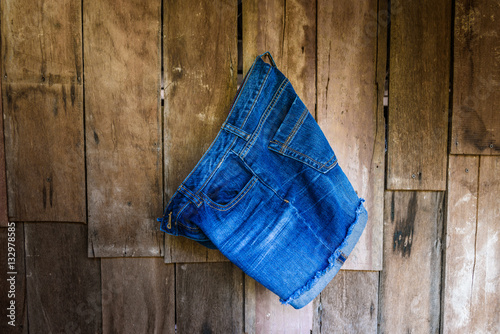 Vintage,Women's jeans shorts hanging on the wall photo