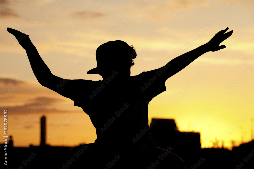 Silhouette of boy in sunset.