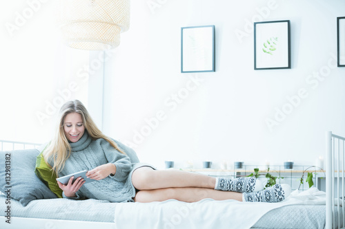 Woman lying with tablet device