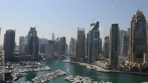 DUBAI, UNITED ARAB EMIRATES, October 27, 2014: Dubai Marina time lapse, day transition overlooking the area's skyscrapers and waterways. Dubai, United Arab Emirates.