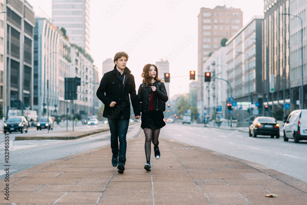 Young beautiful couple in love running outdoor in the city, having fun - first date,  romantic, love concept