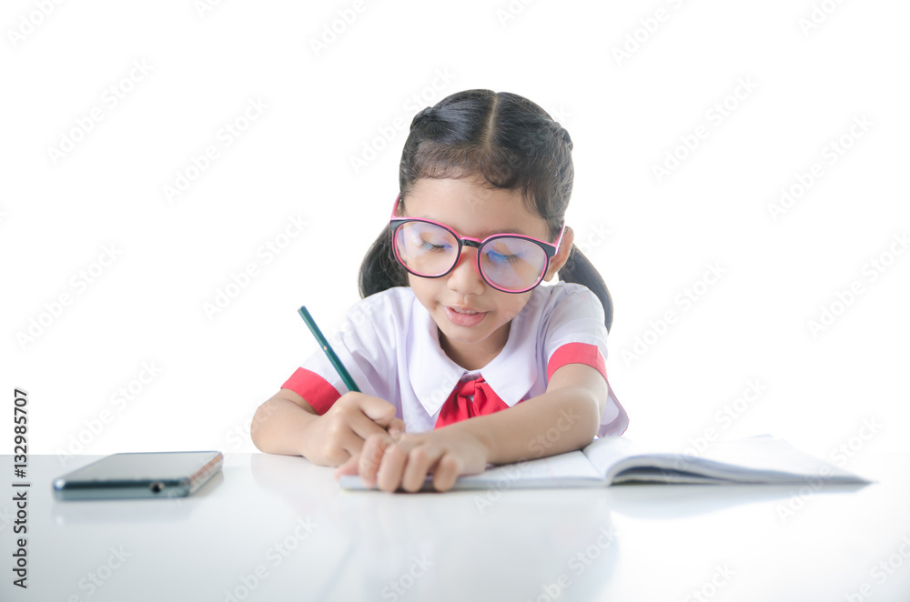 Asian little girl doing homework in Thai Student uniform isolate Asian little girl doing homework in Thai Student uniform isolate