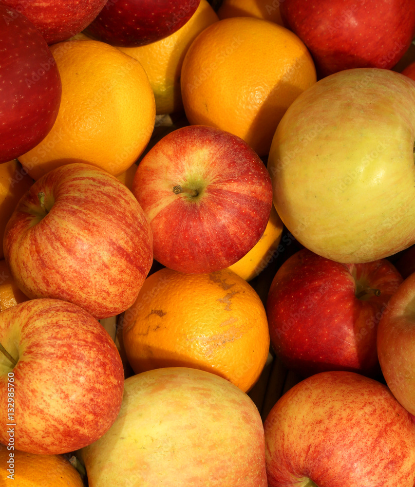 background of ripe apples and oranges orange background of ripe apples and oranges orange