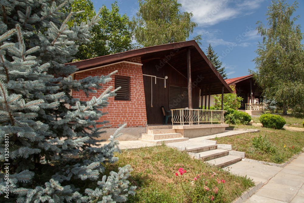 Wooden bungalows and garden in the forest. Holiday apartmens Wooden bungalows and garden in the forest. Holiday apartmens