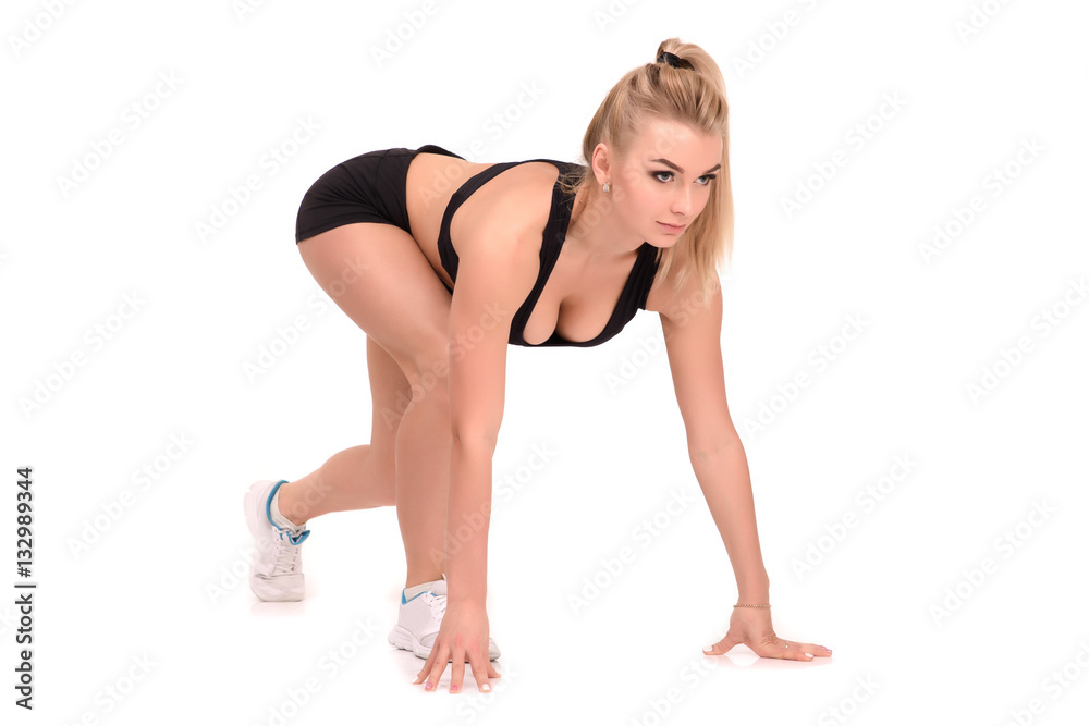Sport woman in position to start running. on white background