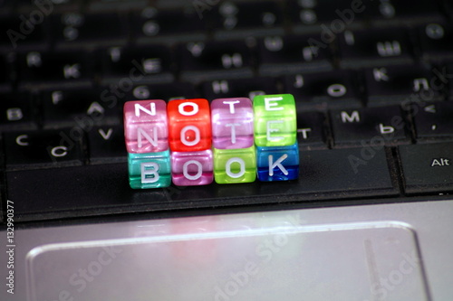 word Notebook of multicolored dice-letters, white chars