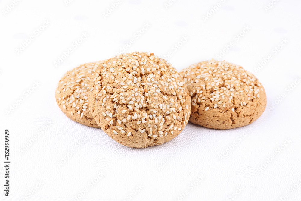 Tasty sweet brown oat cookies on the white cloth on the table in cafeteria or restaurant.