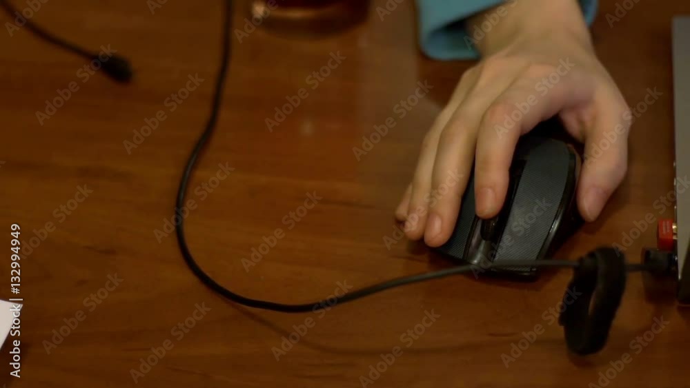 man working at his laptop and clicks on the computer mouse man working at his laptop and clicks on the computer mouse