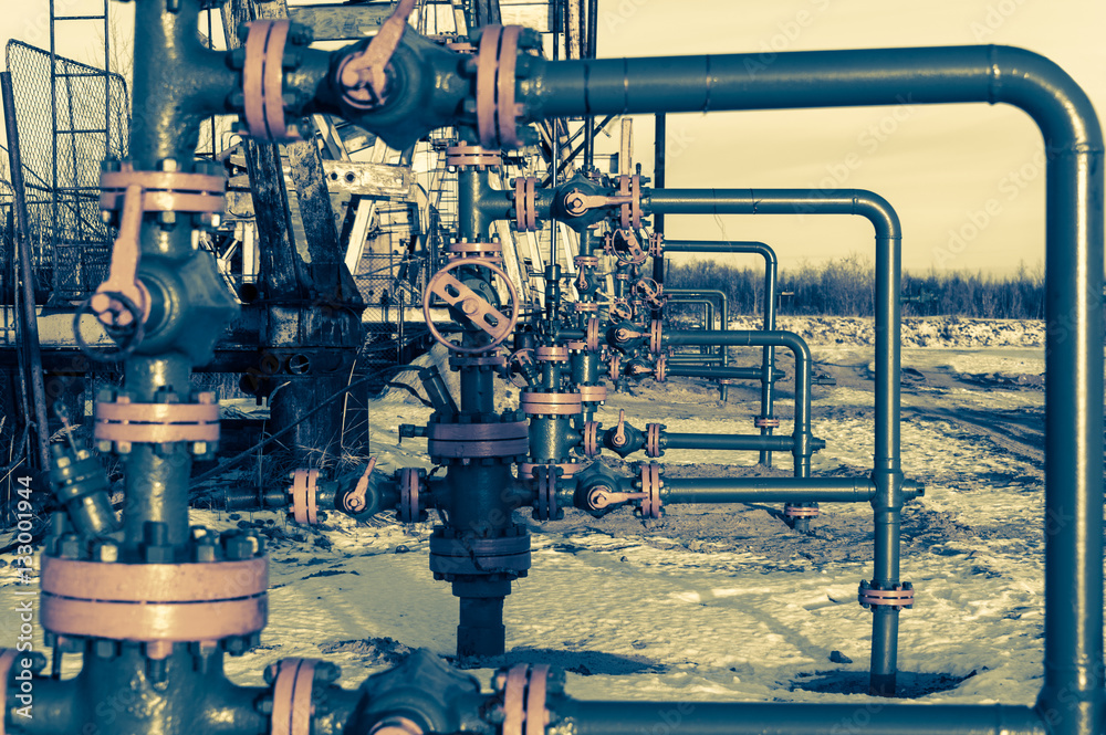 Group of wellhead. Oilfield with sand ground. Oil and gas . Toned. Group of wellhead. Oilfield with sand ground. Oil and gas . Toned.