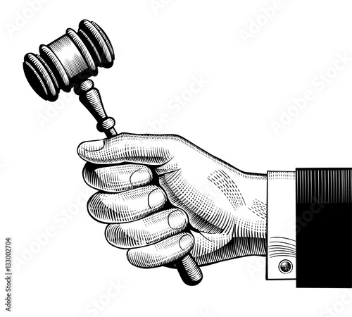 Hand holding judges gavel