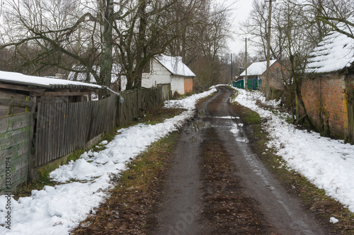 Winter landscape with empty street of rural village Pidstavky, Sumskaya oblast, Ukraine