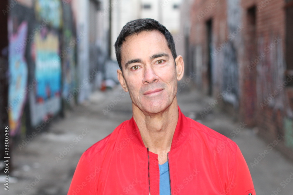 Portrait Of A Mature Active Man Smiling In town - Stock image Portrait Of A Mature Active Man Smiling In town - Stock image