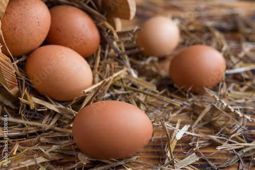 Brown eggs in the straw close-up in a rustic style