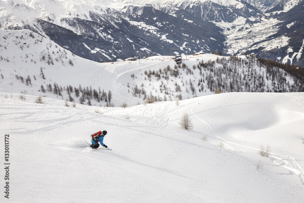 Man snowboarding downhill in powder snow Man snowboarding downhill in powder snow
