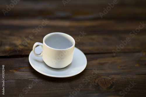 Empty white coffee cup and saucer