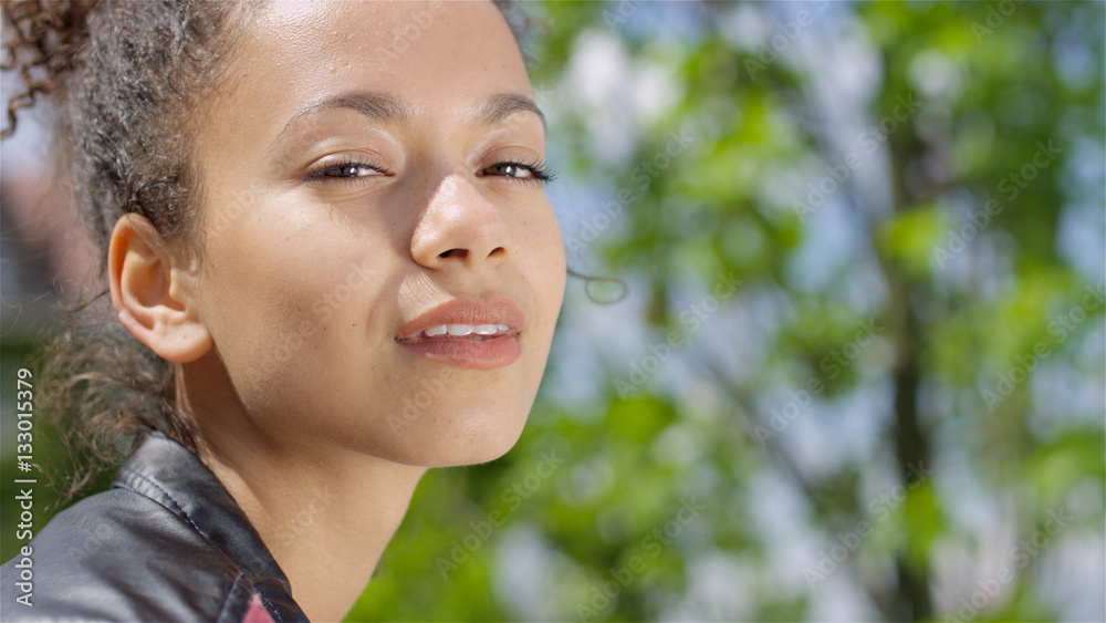 Closeup portrait of a beautiful mixed race woman smiling warmly to a camera. Closeup portrait of a beautiful mixed race woman smiling warmly to a camera.