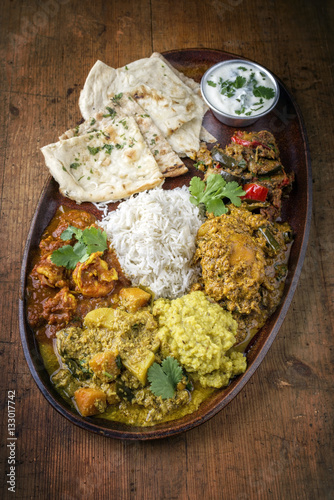 Traditional Indian Curry Dishes as close-up on a Plate photo