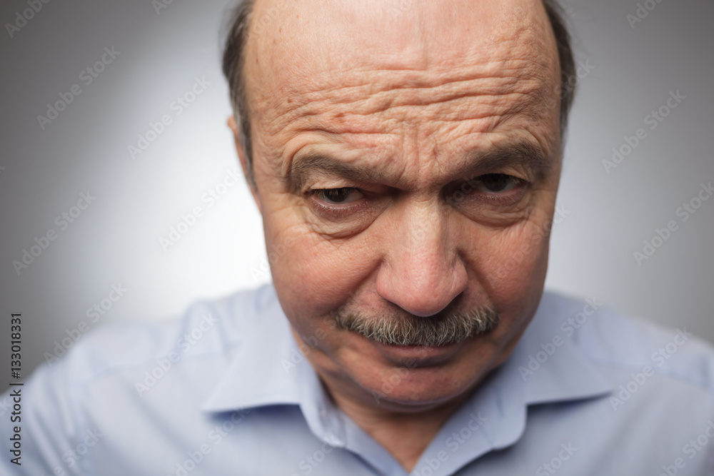 Elderly man dissatisfied frowns and looks sullenly. Elderly man dissatisfied frowns and looks sullenly.