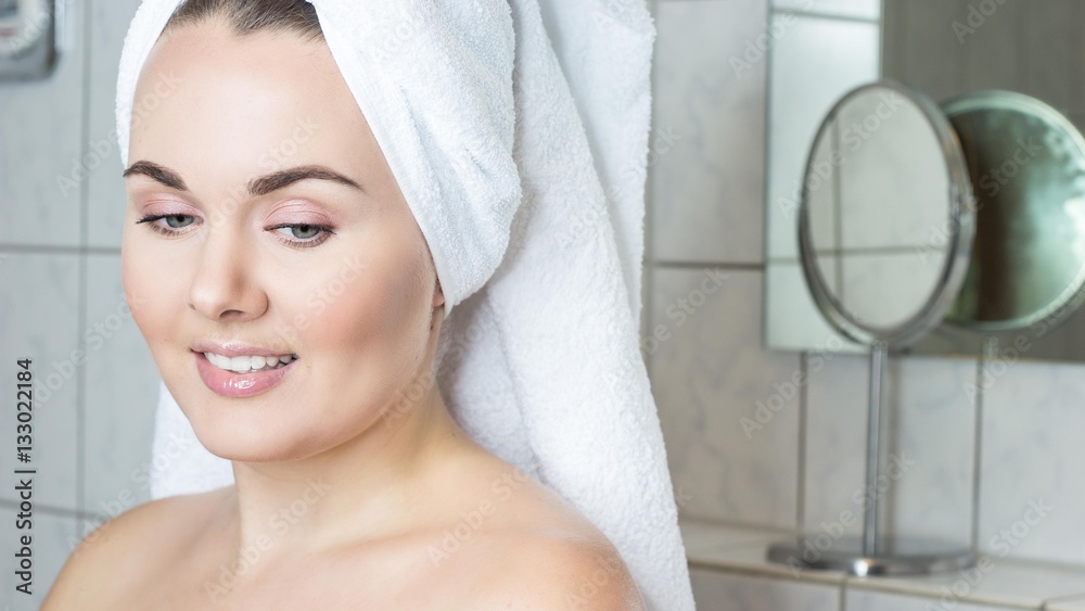 Happy young woman with a white towel on her head. The girl after a shower in a towel. Happy young woman with a white towel on her head. The girl after a shower in a towel.