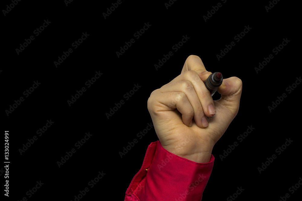 Fototapeta premium Hand holding marker isolated on black