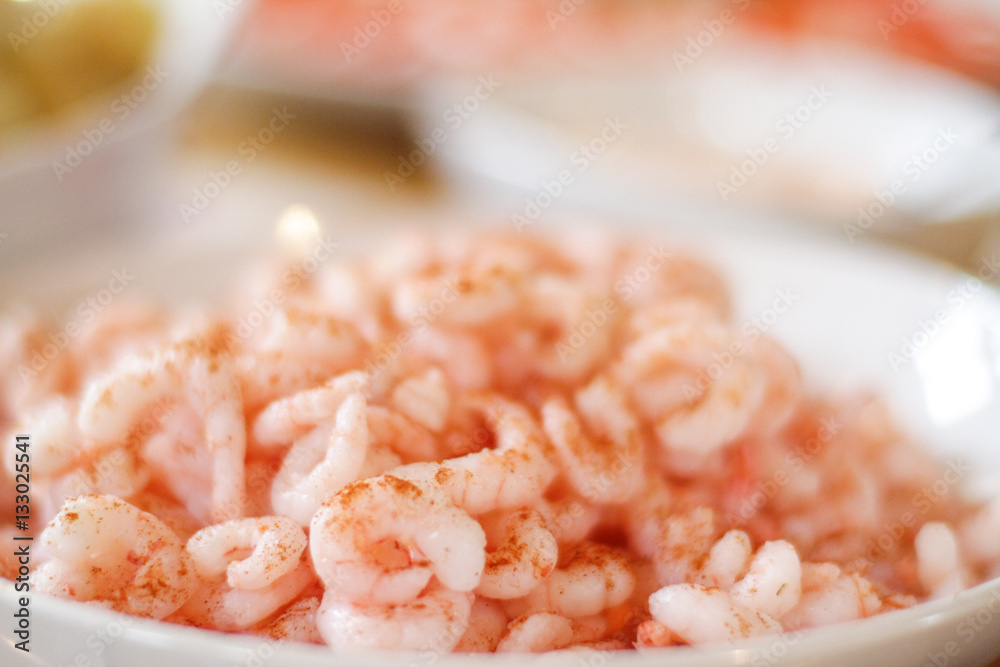 White bowl of fresly boiled shimps on the table White bowl of fresly boiled shimps on the table