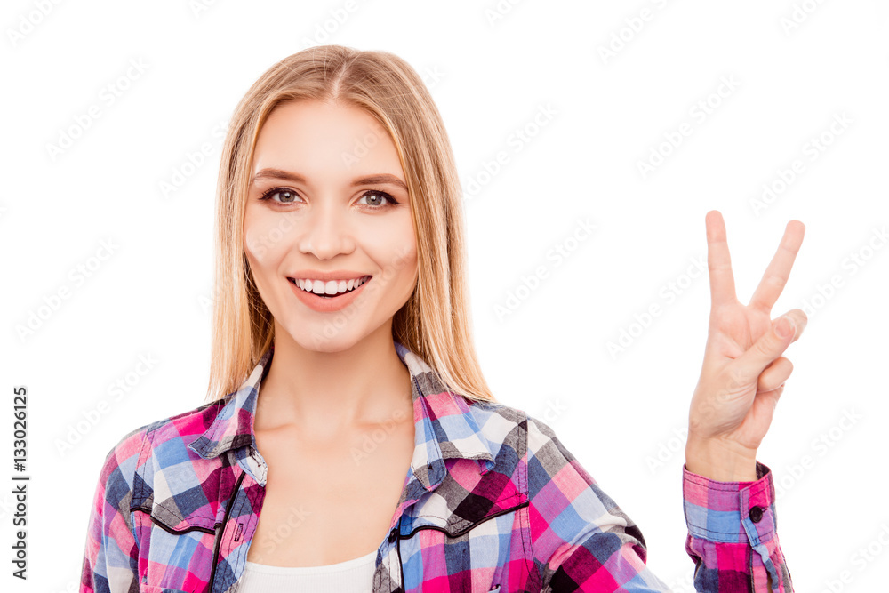 Pretty young woman with beaming smile showing v-sign Pretty young woman with beaming smile showing v-sign
