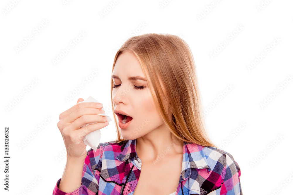 Portrait of sick blonde woman with fever sneezing in tissue Portrait of sick blonde woman with fever sneezing in tissue