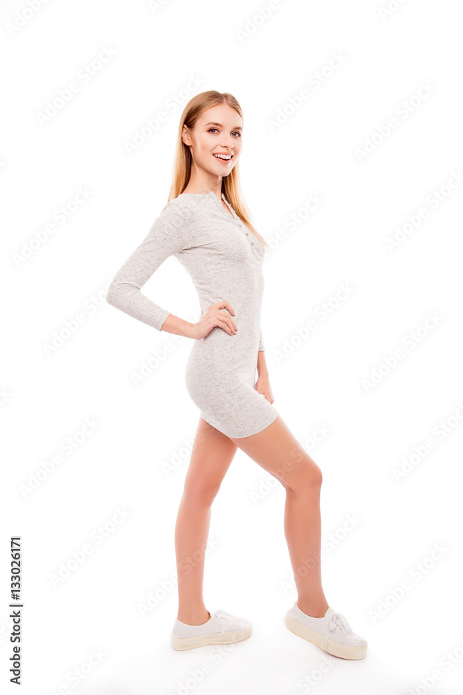Full photo of attractive young woman in gray dress on white back Full photo of attractive young woman in gray dress on white back