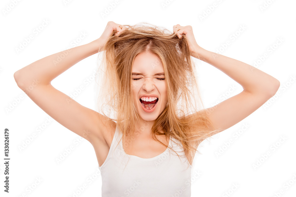 Sad pretty girl holding her damaged hair and shouting Sad pretty girl holding her damaged hair and shouting