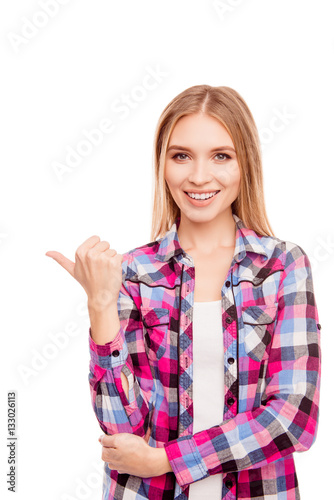 Portrait of happy cheerful blonde showing dirction with finger