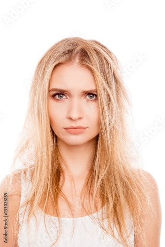 Portrait of sad blonde woman with dry damaged hair